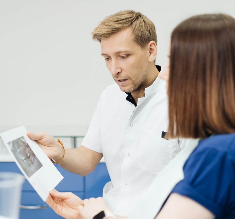 doctor-consulting-his-patient-discussing-tooth-treatment-plan-health-care.jpg